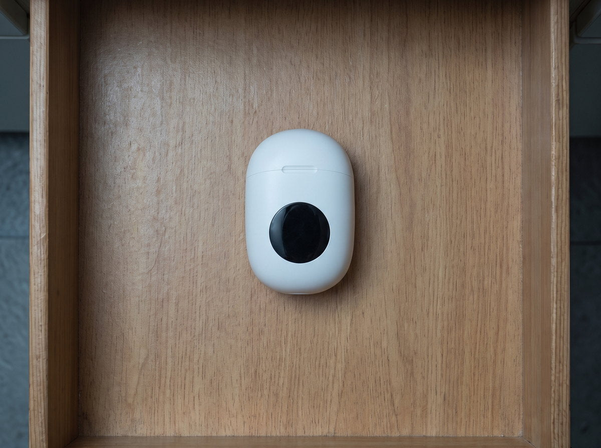 The white charging case alone in the same drawer, now cleared out.